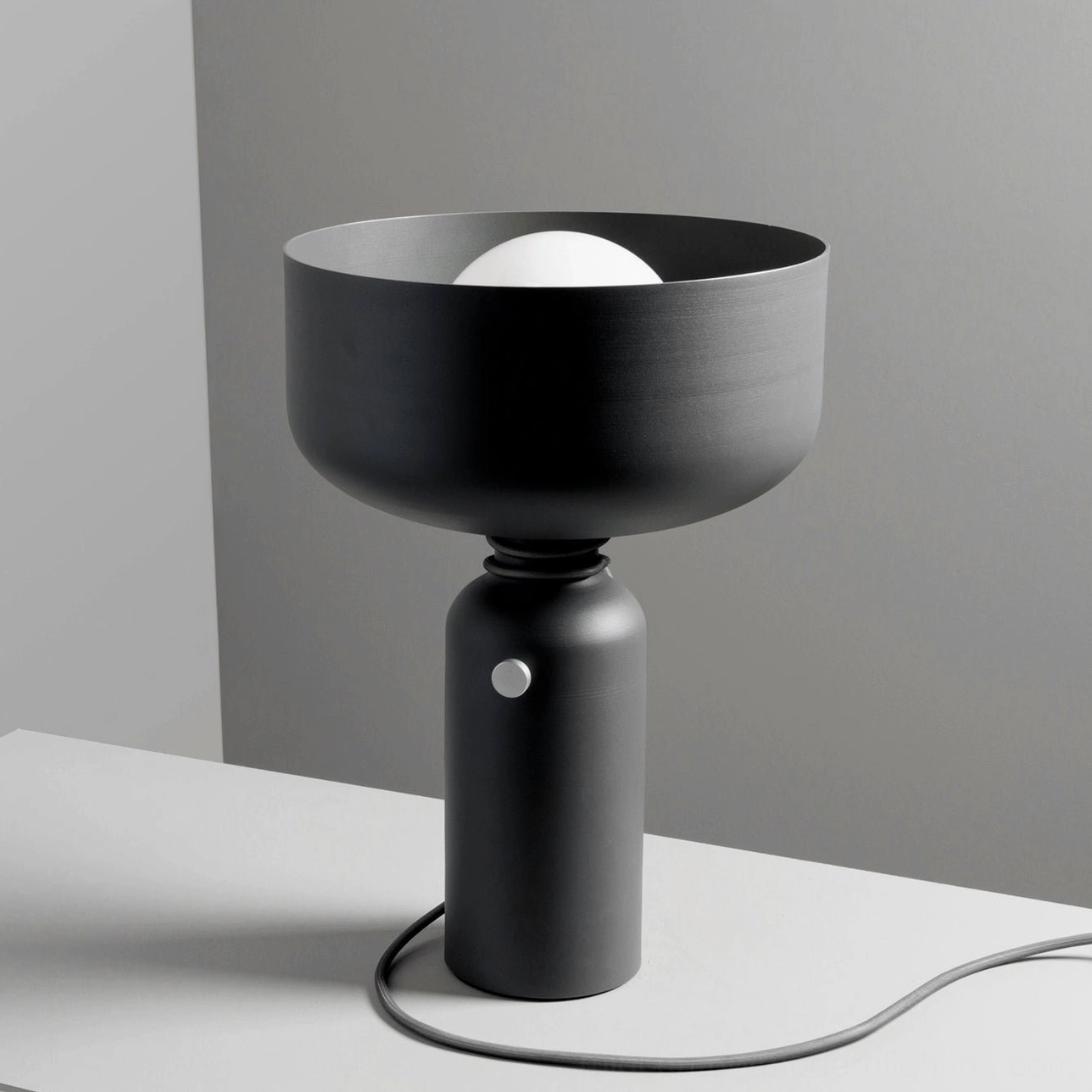 Vol black table lamp side perspective showing braided cord wrap and cylindrical base