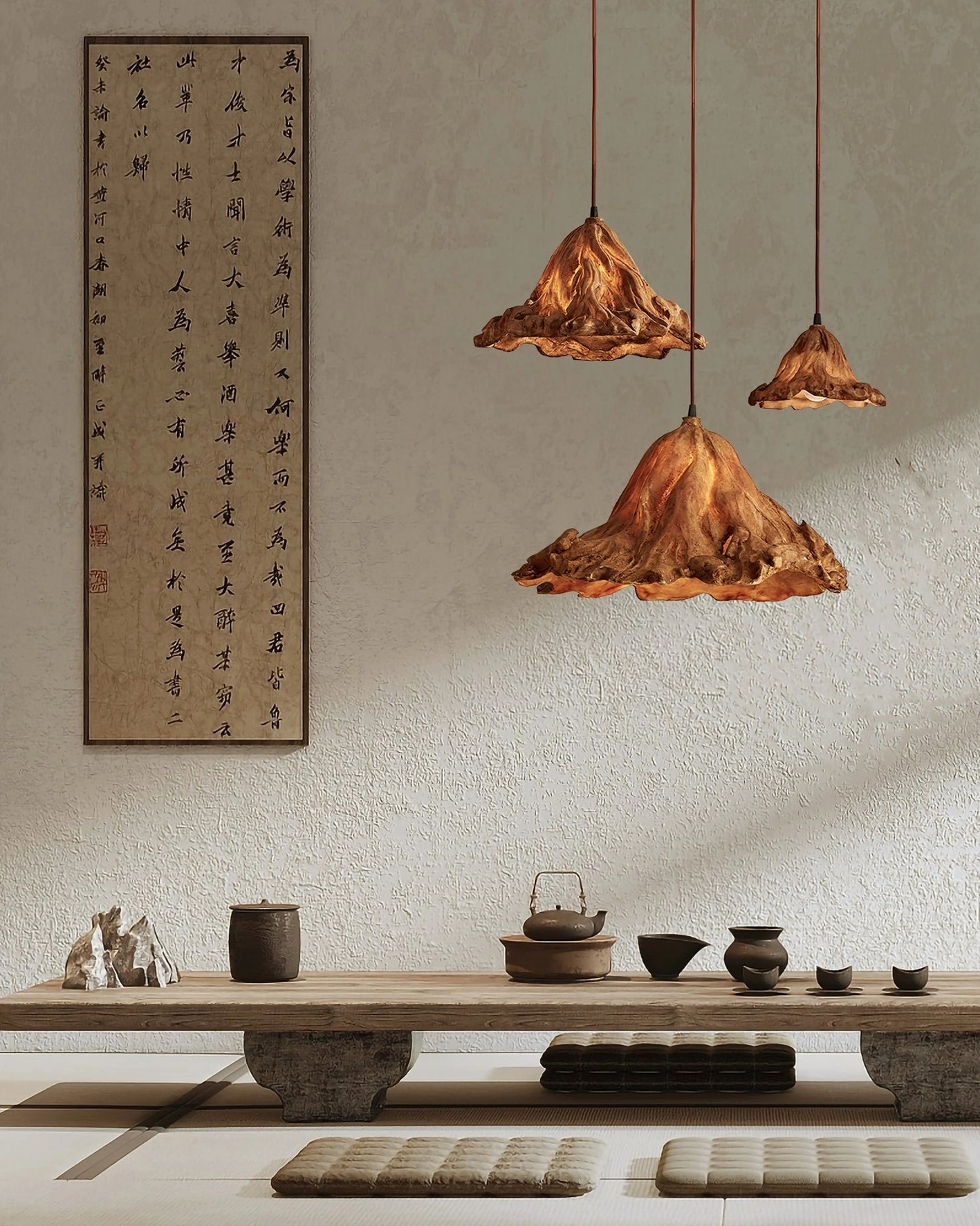 Mixed-size brown Volcano pendant lamps in traditional Japanese tea room setting with calligraphy and low wooden table