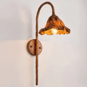 Volcano wall lamp with curved arm and illuminated LED bulb, close-up front detail view showing textured brown walnut finish