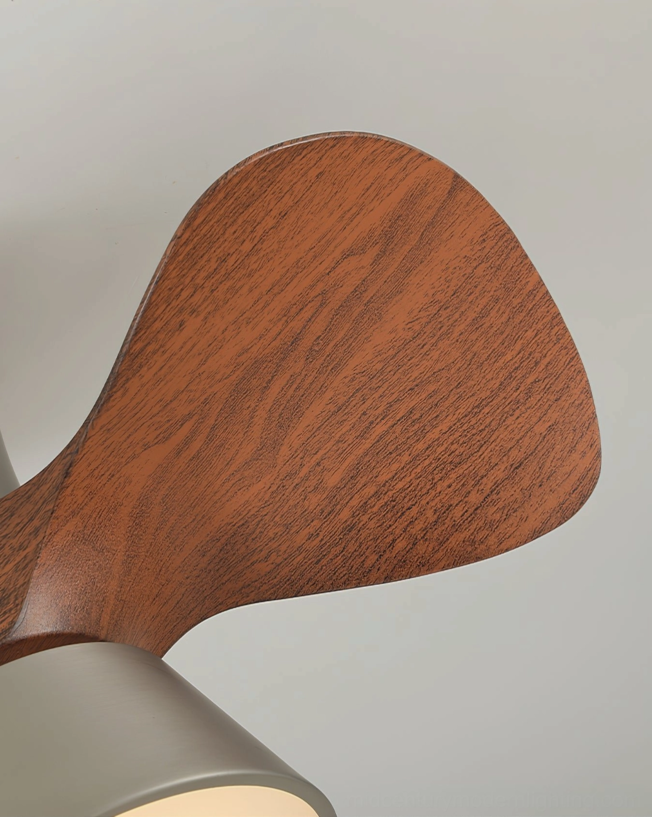 Individual walnut wood blade of Volos ceiling fan showcasing curved aerodynamic shape and natural grain