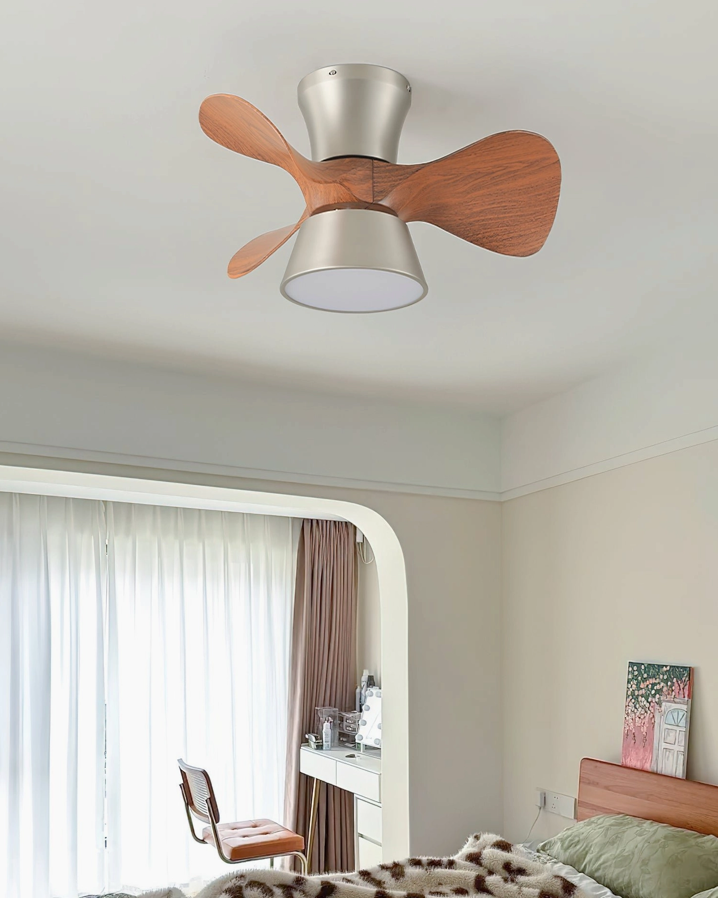Modern ceiling fan light fixture in contemporary bedroom with arched entryway and vanity desk setup