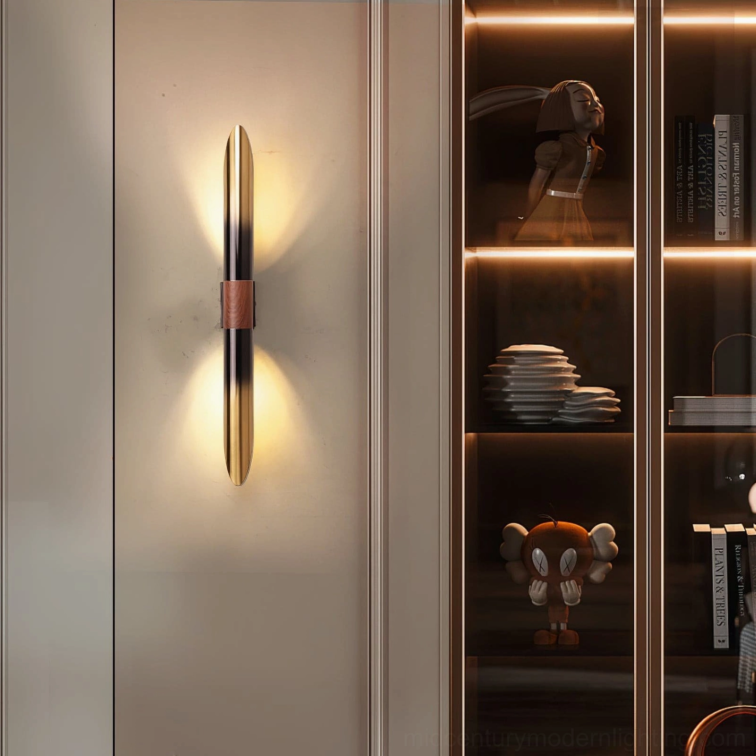 Voya wall lamp with gradient metal finish beside glass display cabinet, warm backlight