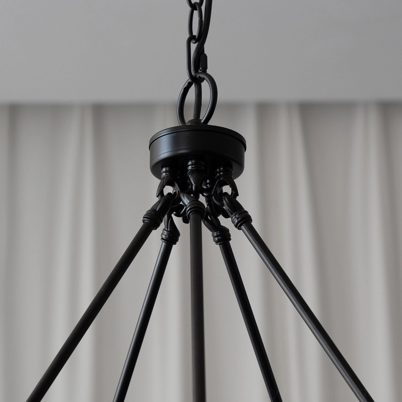 Close-up detail of heavy-duty ceiling mount hardware and suspension chains for wagon wheel chandelier installation