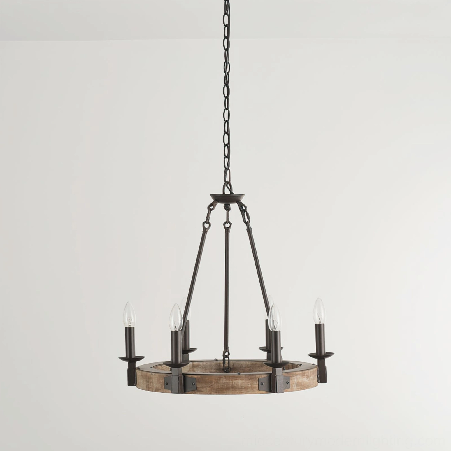 Wagon wheel chandelier distant rear overhead view showing small profile and four unlit candle bulb positions against neutral wall