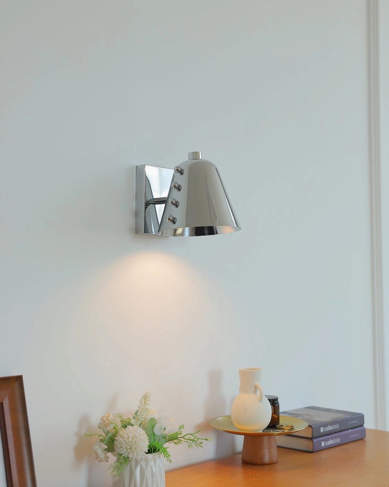 Geometric wall lamp styled in minimalist bedroom reading nook with soft illumination