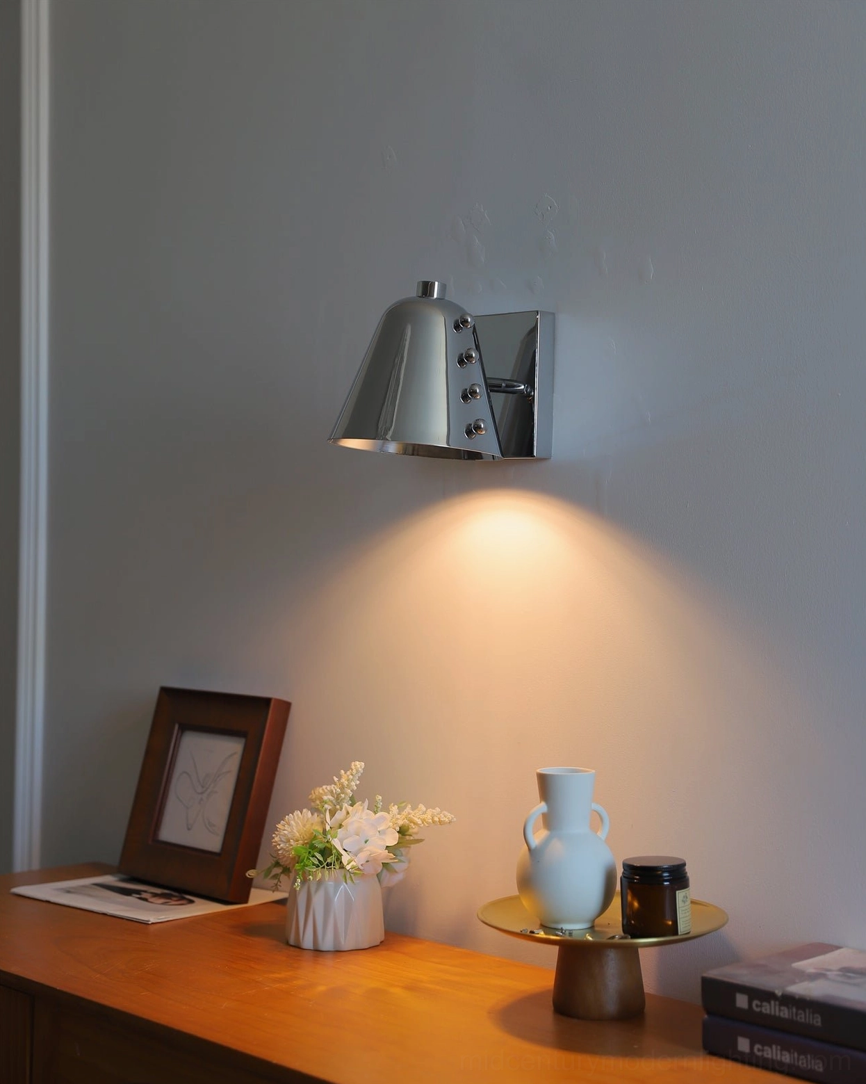 Geometric wall sconce in entryway creating sophisticated first impression foyer design