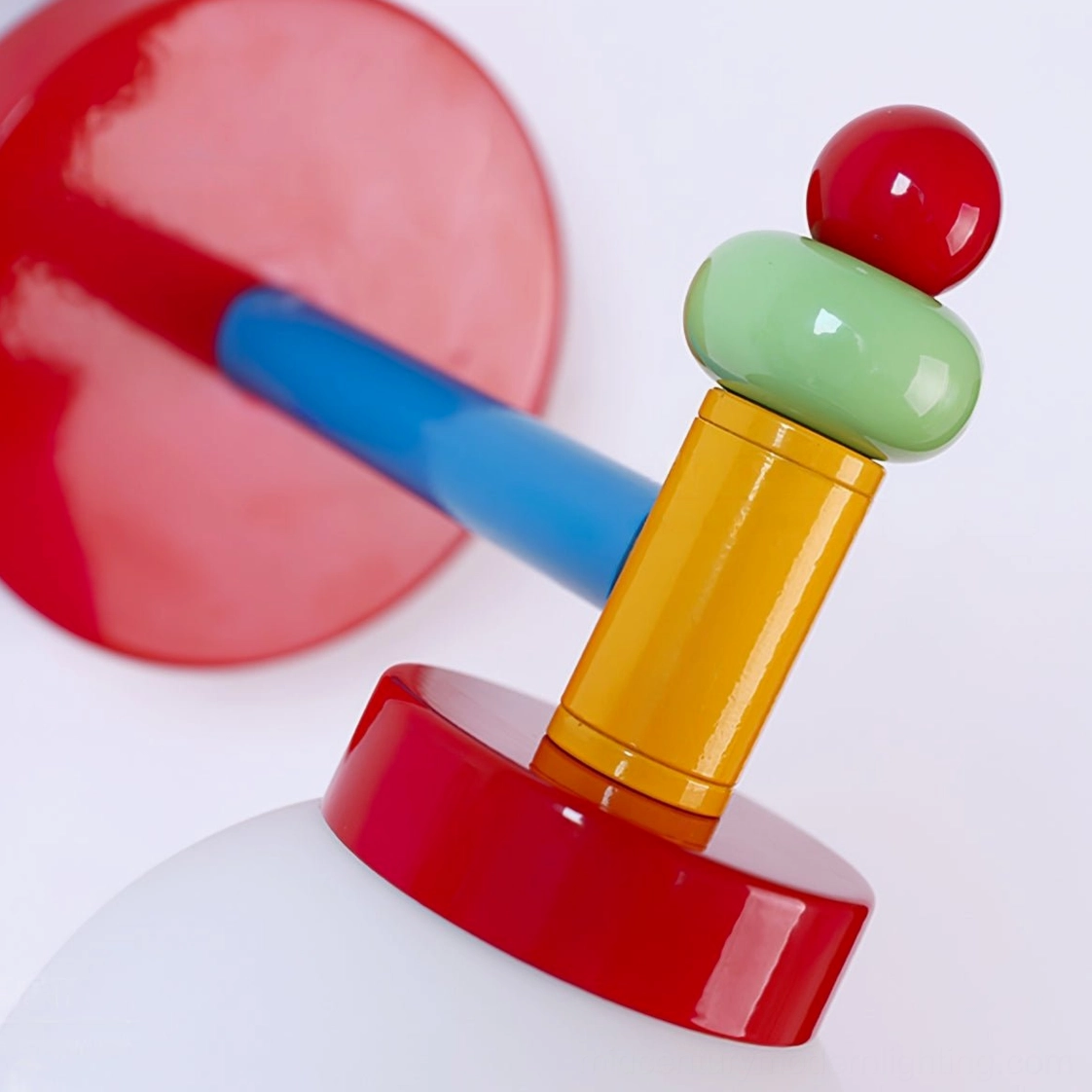Macro closeup of precision metal connectors and colored knobs in modern wall light fixture