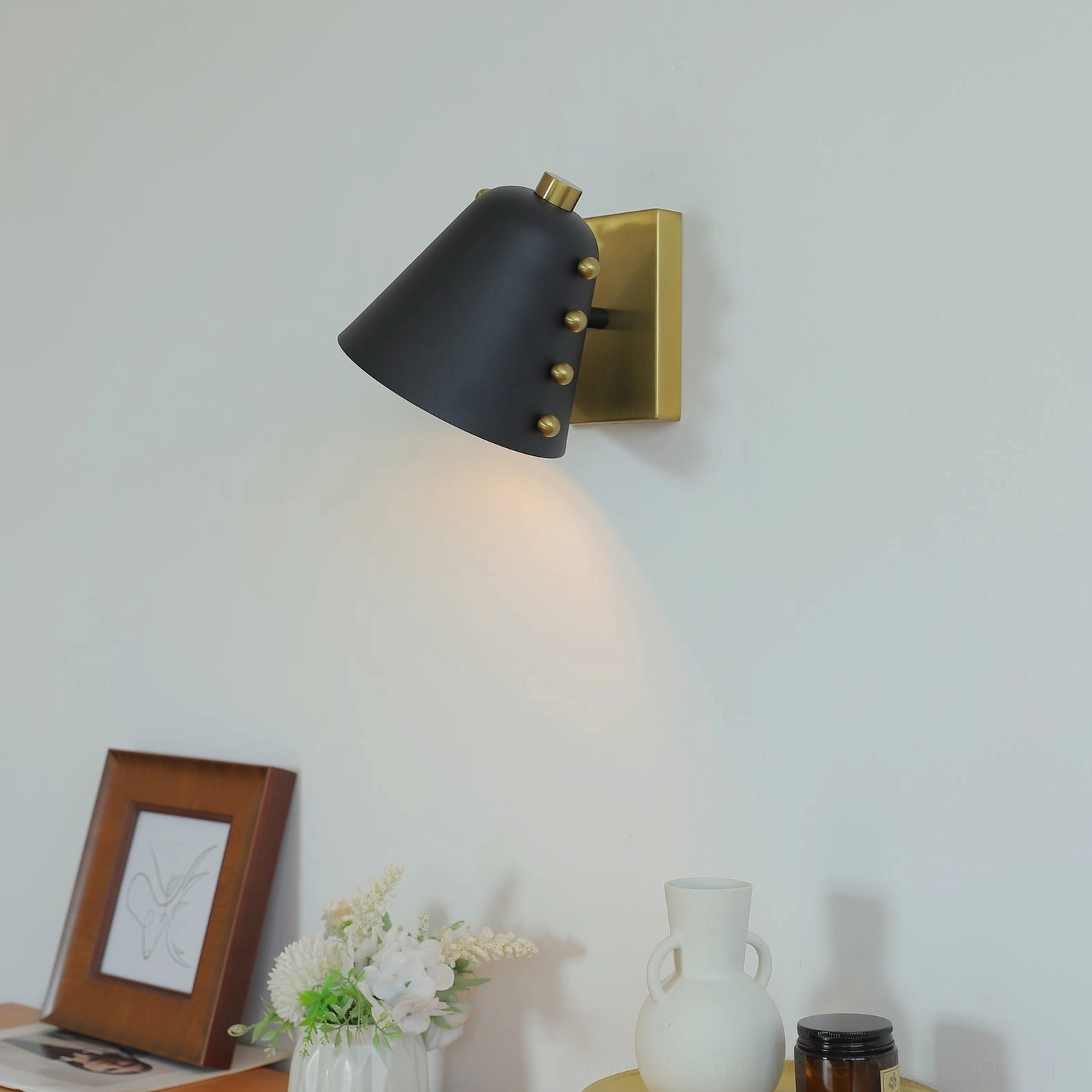 Wall sconce in home office environment providing focused ambient lighting for workspace