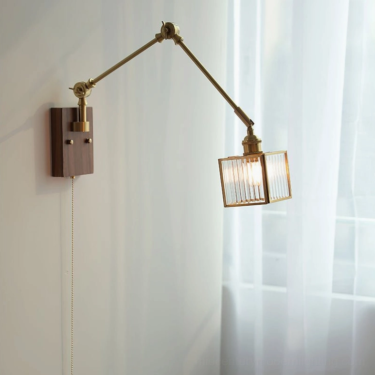 Dark walnut swing arm wall lamp with brass fittings and ribbed glass shade providing directional task lighting in modern interior