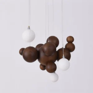 Dark walnut wood ball pendant light with integrated LED illumination and wabi-sabi sculptural design against neutral backdrop