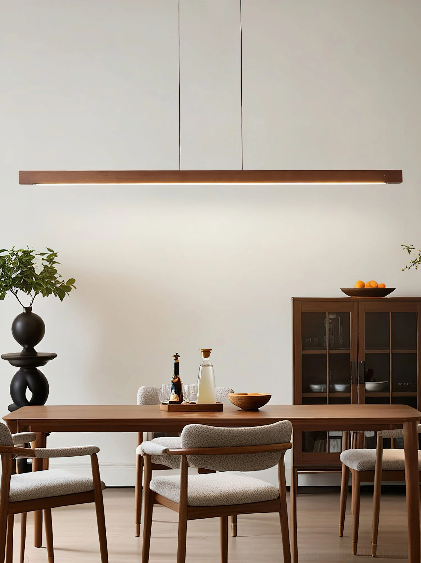 Dark walnut linear LED pendant fixture in contemporary dining space with wooden furniture and modern decor