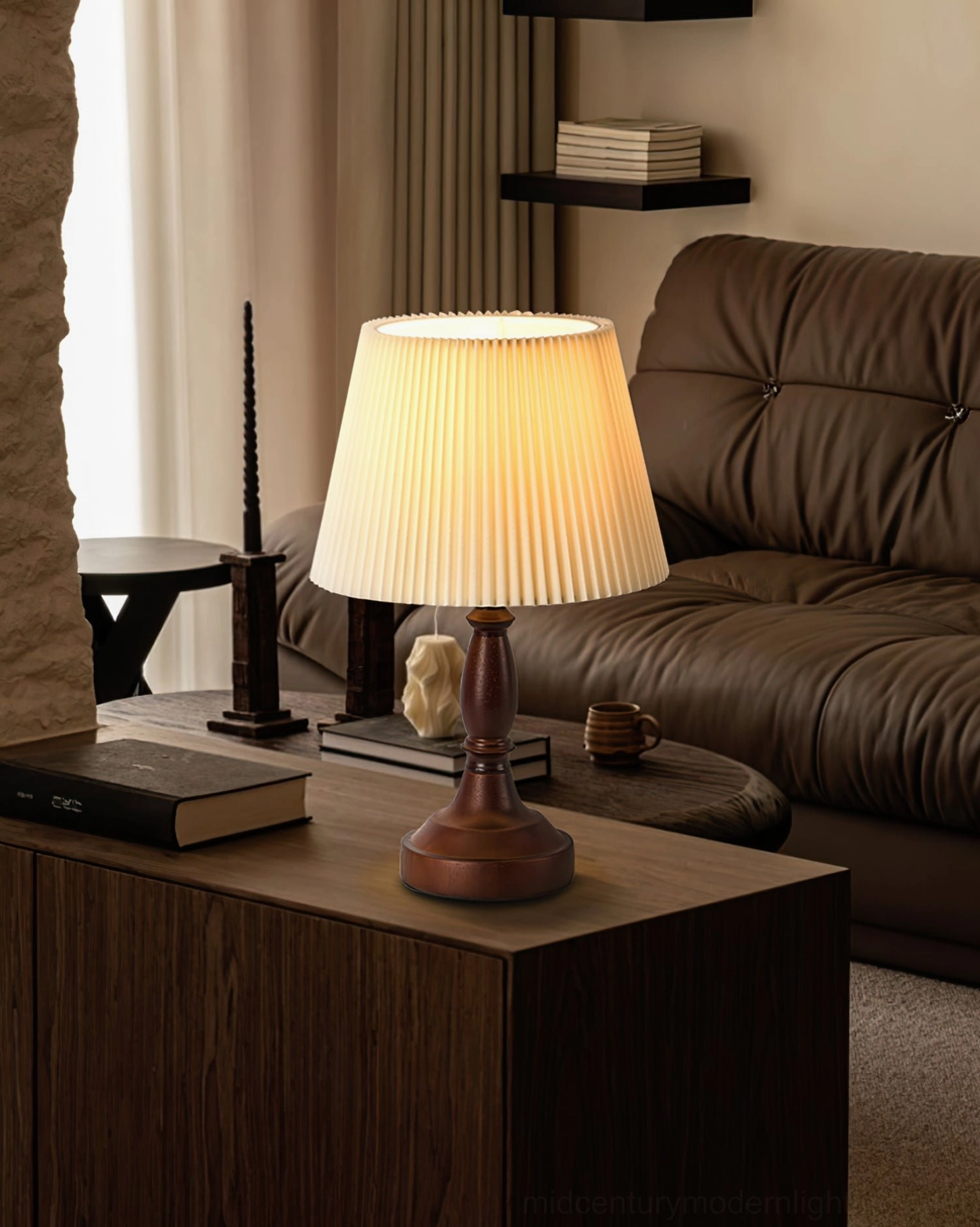 Mid-century modern table lamp on dark wood side table next to leather sofa in contemporary living room