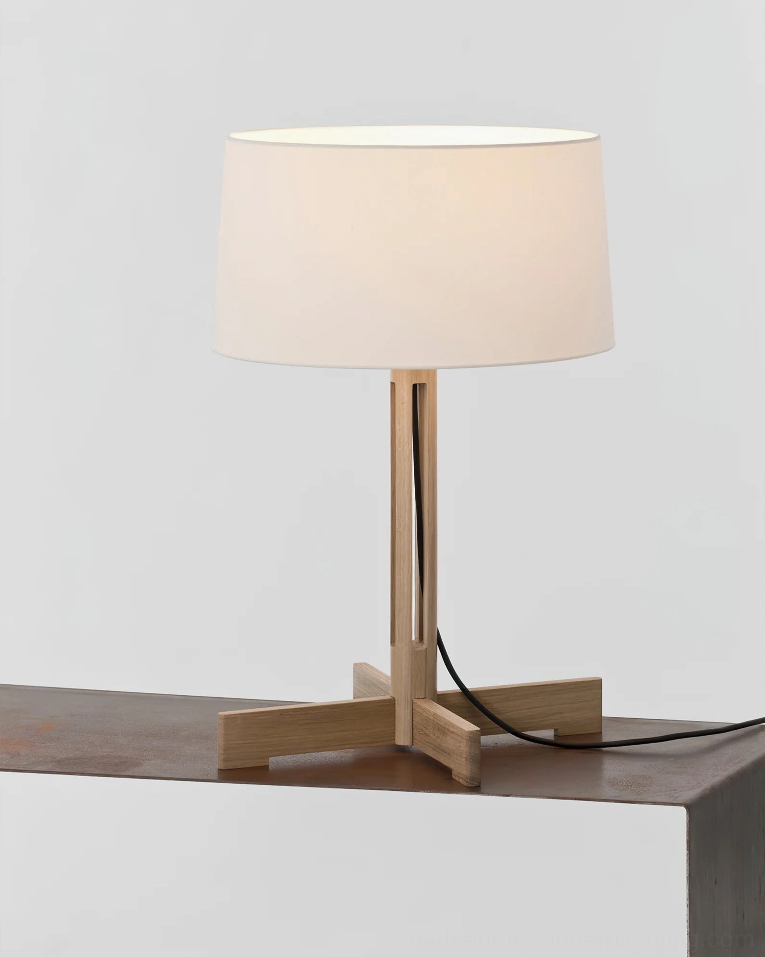 Dark walnut wood sculptural table lamp on minimalist display shelf, architectural design