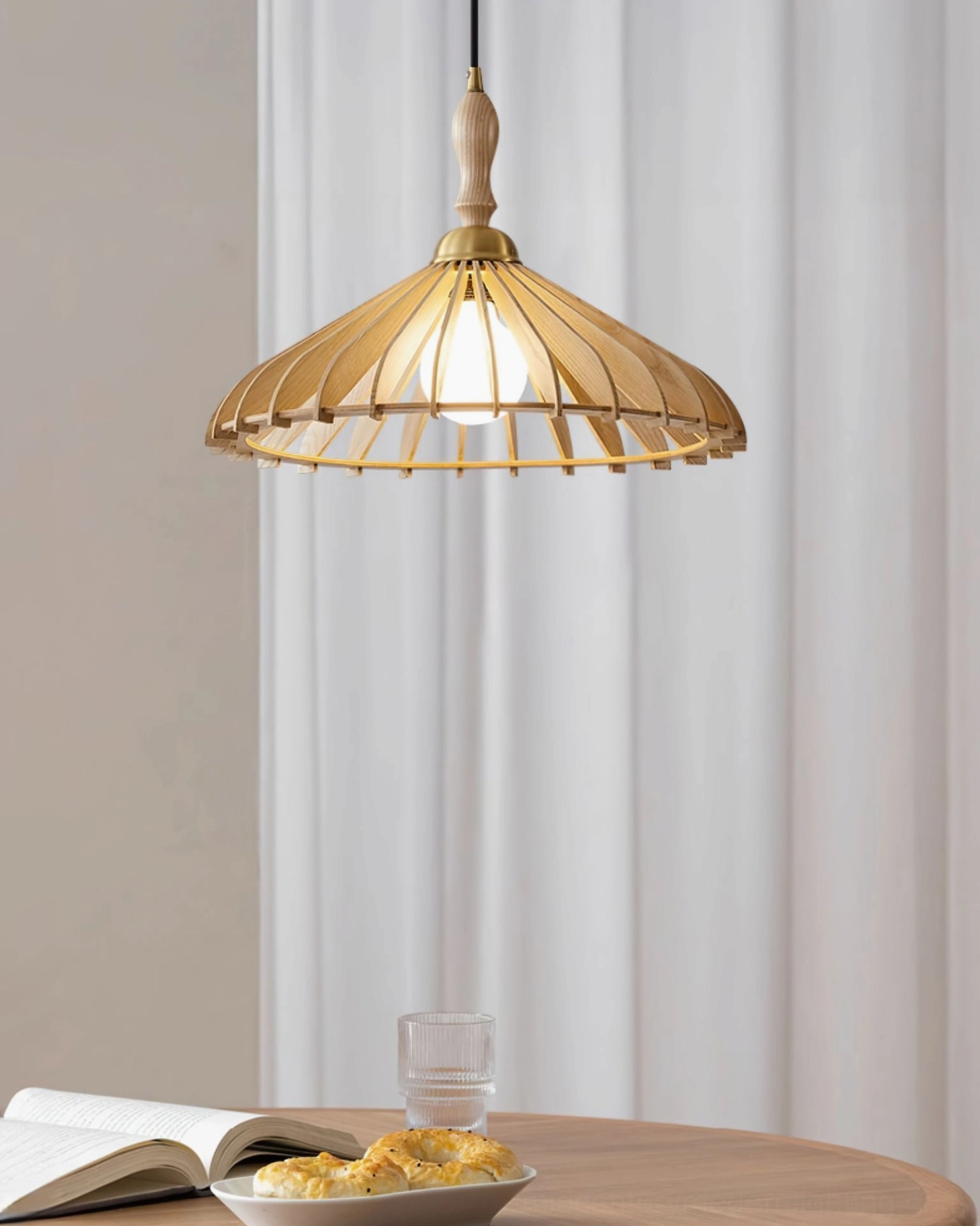 Single walnut umbrella wood pendant suspended from ceiling, warm dappled light distribution shown