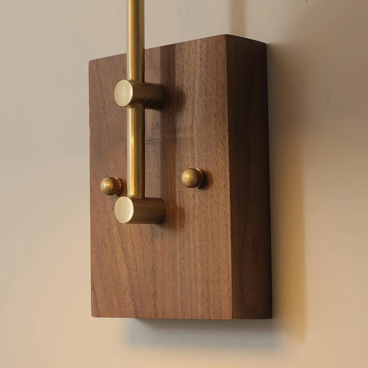 Solid walnut wood backplate with brass top fixture mounting, mid-century modern wall lamp installation detail
