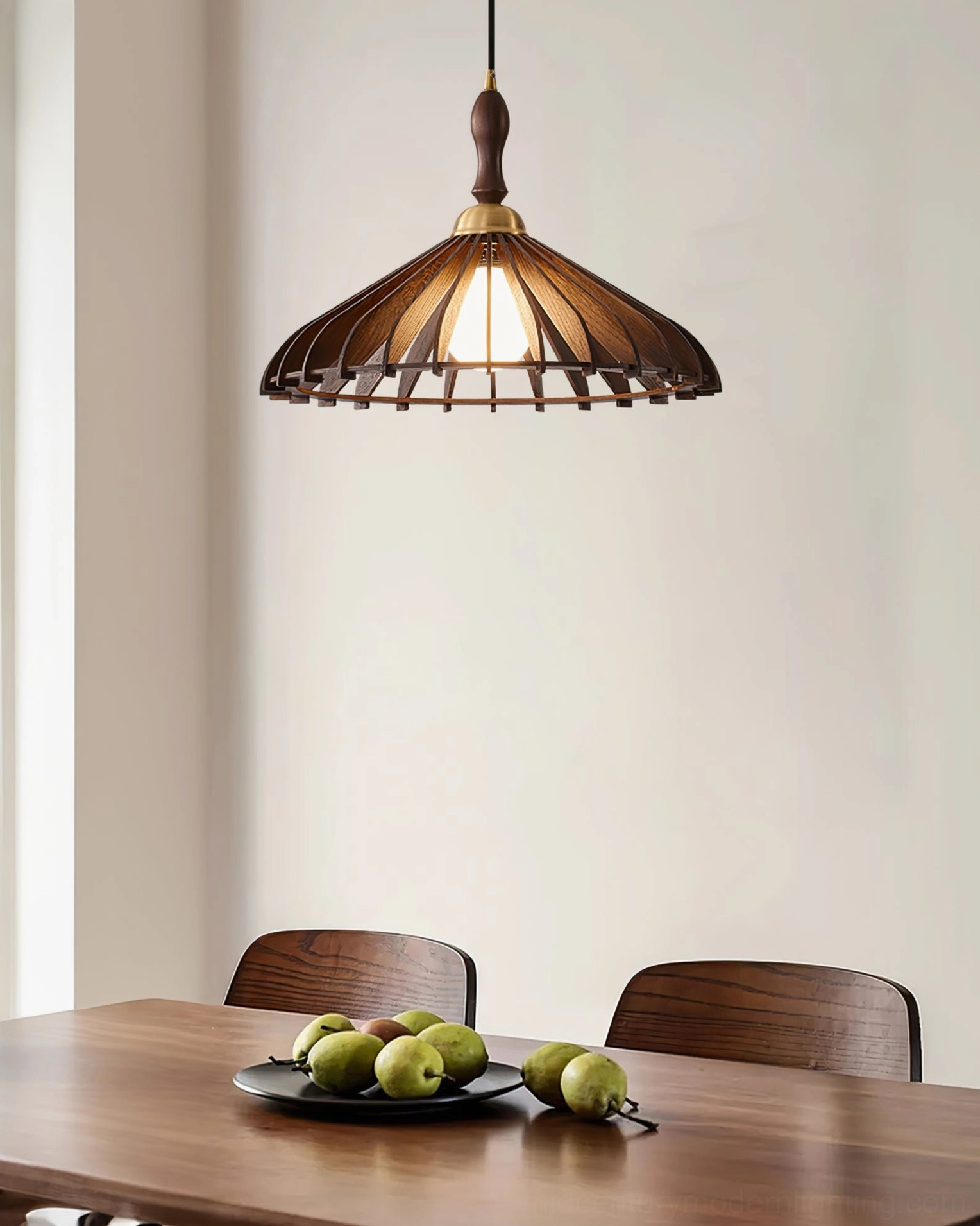 Dark brown walnut wooden pendant lamp with brass accents, front eye-level view in empty dining room