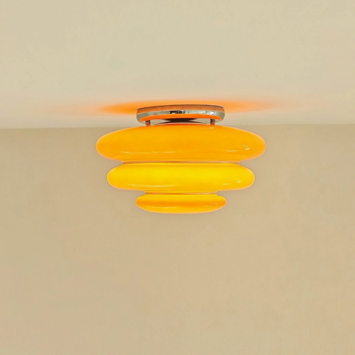 Warm glowing tiered orange ceiling lamp three-layer stacked design