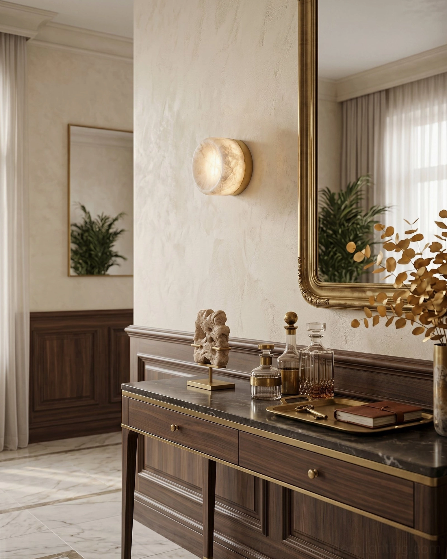 Alabaster disc sconce beside dark wood bathroom vanity cabinet with gold mirror frame, showing warm light diffusion