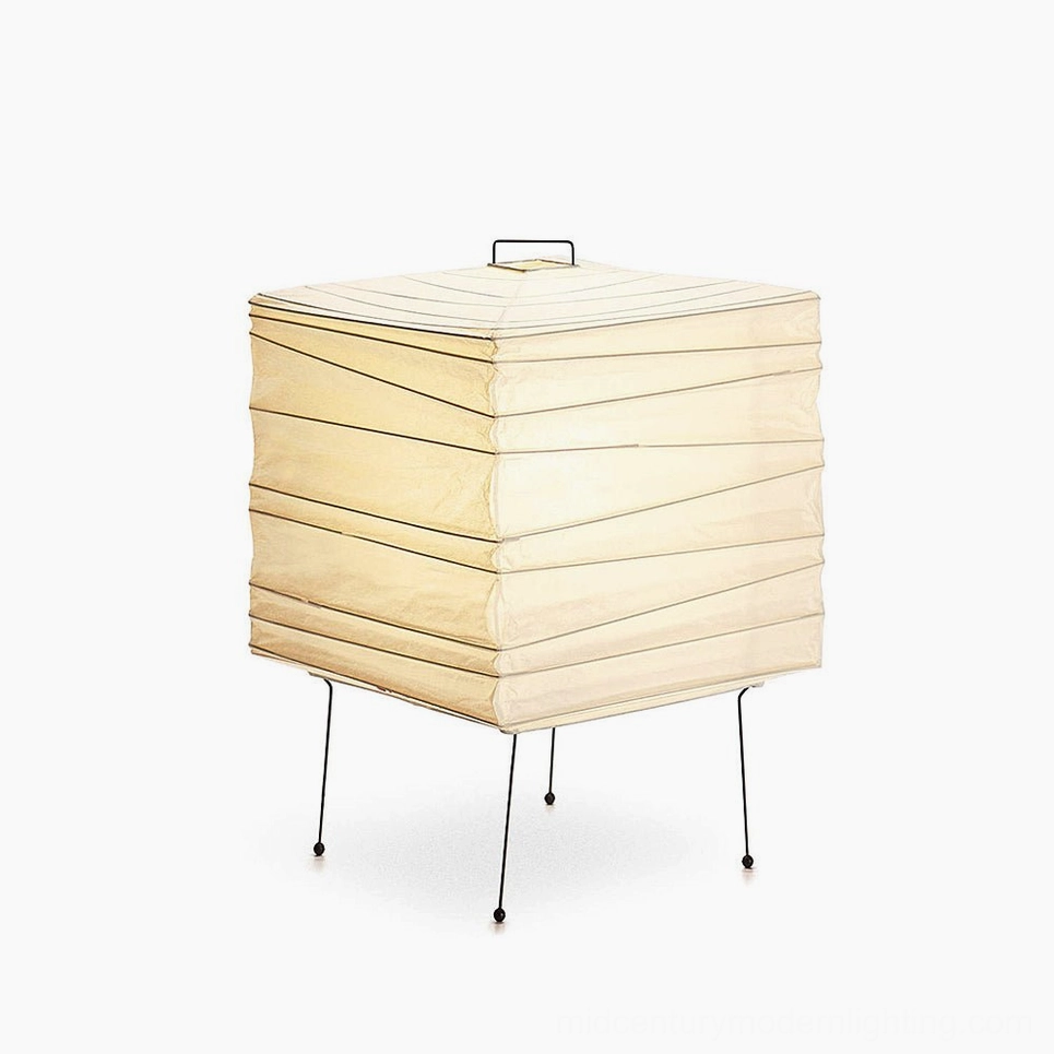 Side profile of artisanal washi paper table lamp showing undulating cylindrical form, metal support frame, and paper shade light diffusion
