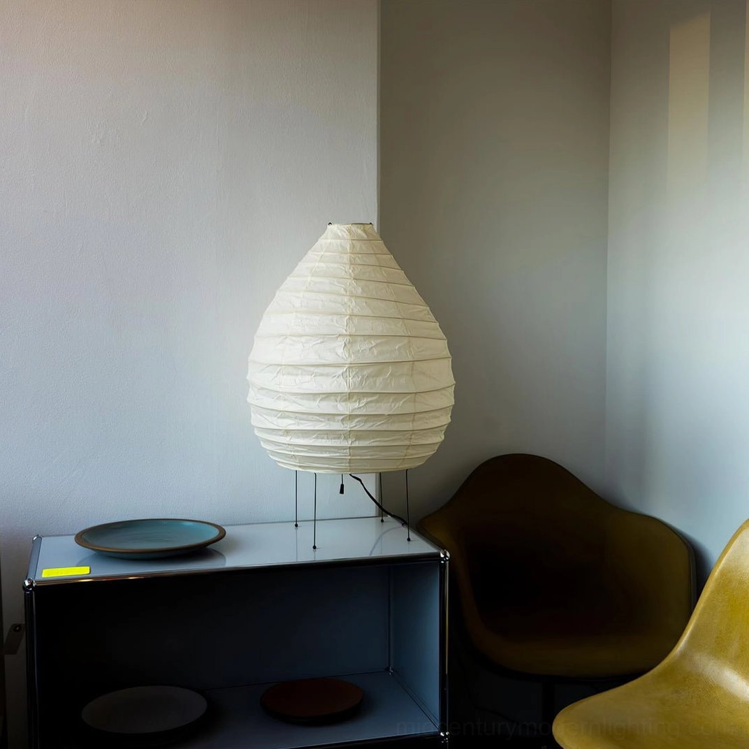 Three-quarter angle view of handcrafted mulberry washi paper table lamp with iron frame