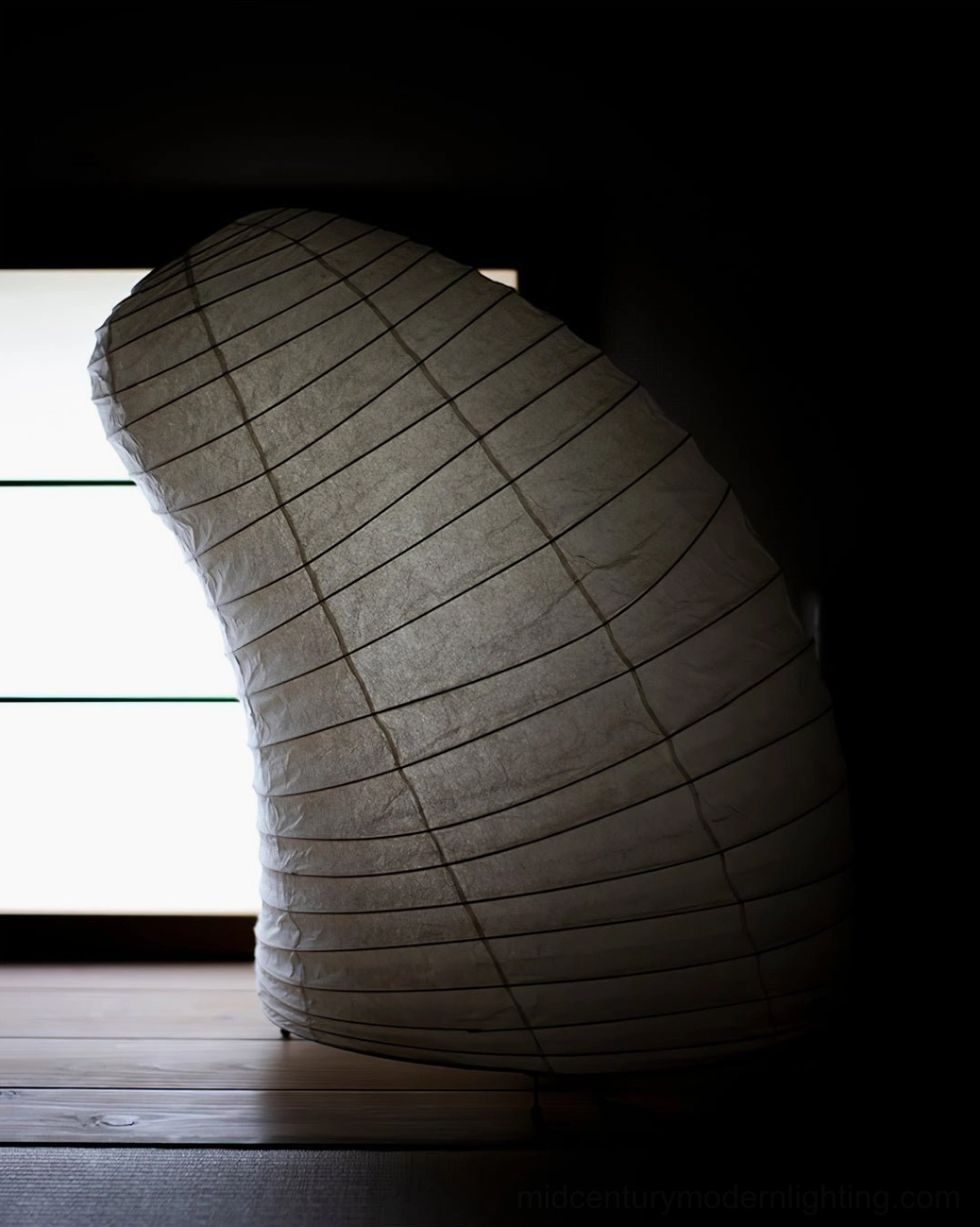 Washi paper table lamp side back view in Japanese shoji window room, dim minimalist dark paper shade demonstrating mood lighting capability