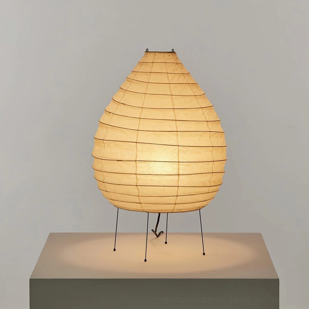 Lit washi paper table lamp glowing with warm ambient light, tabletop display on pedestal
