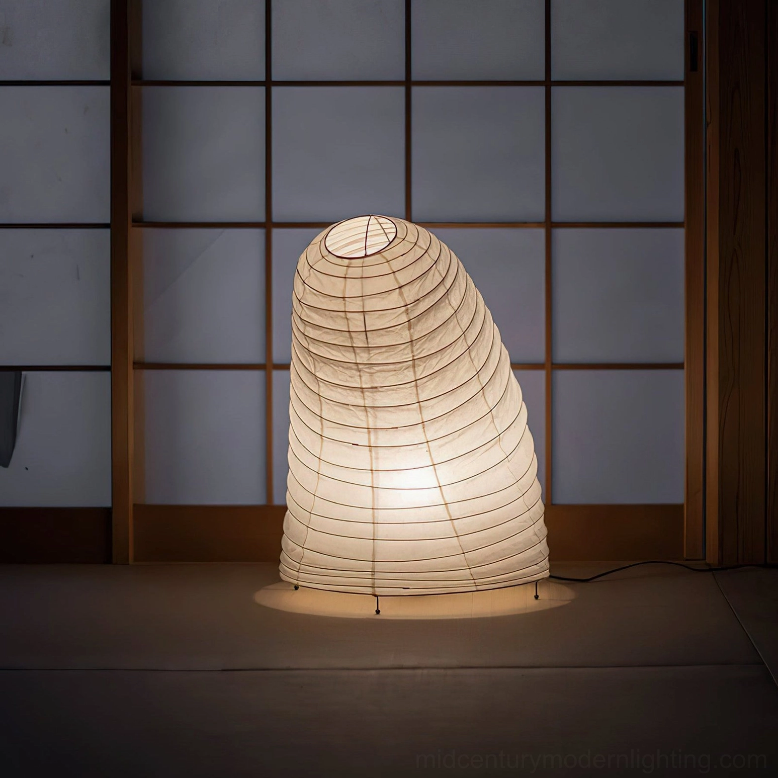 Neutral minimalist washi paper table lamp glowing softly in Japanese shoji screen room, front-facing view demonstrating diffused illumination