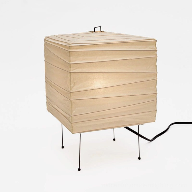 Handcrafted organic washi paper table lamp with living creature-inspired sculptural design, perforated shade creating artistic light patterns and ambient glow