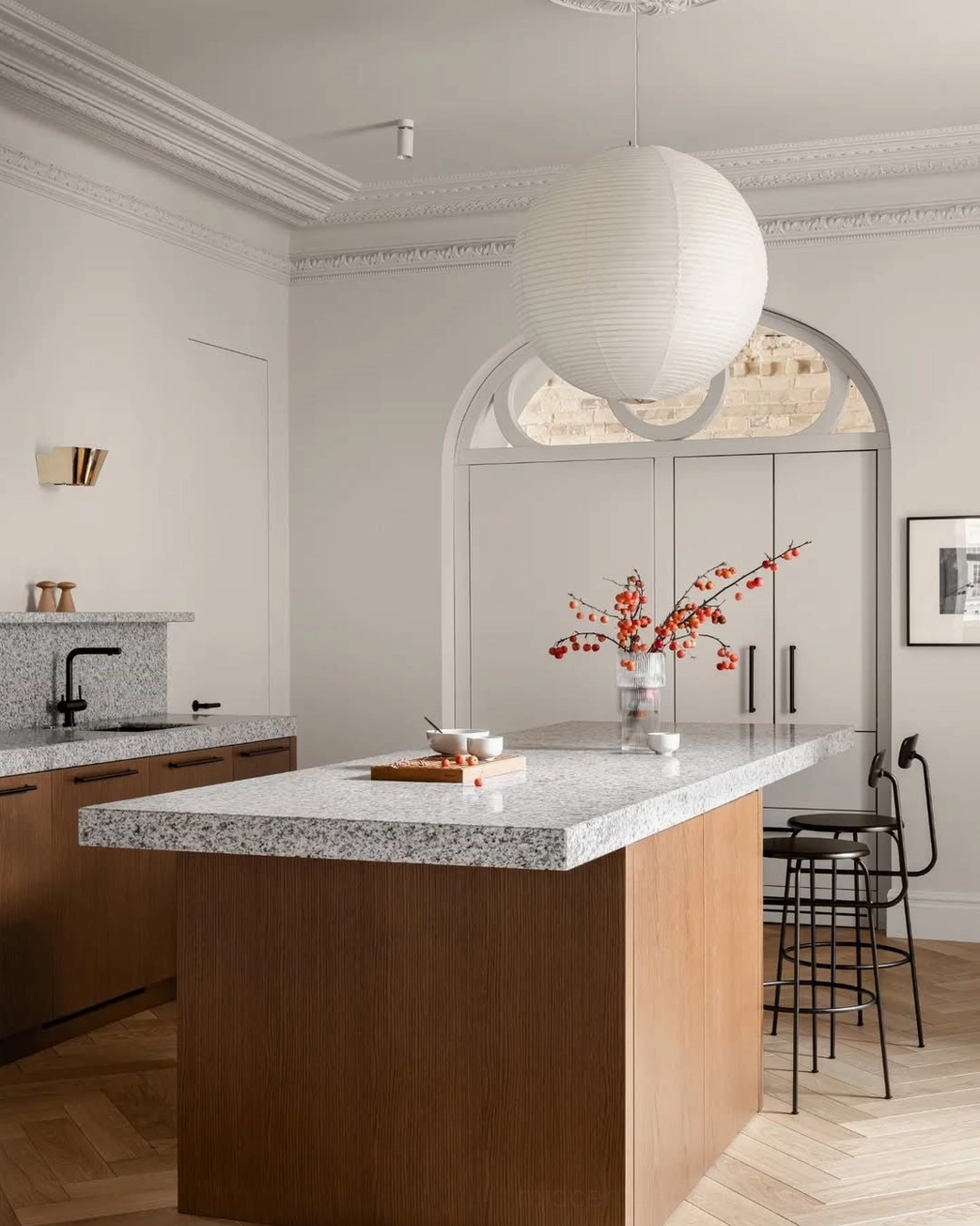 Large white washi paper pendant light hanging over modern kitchen island, elegant European residential kitchen space