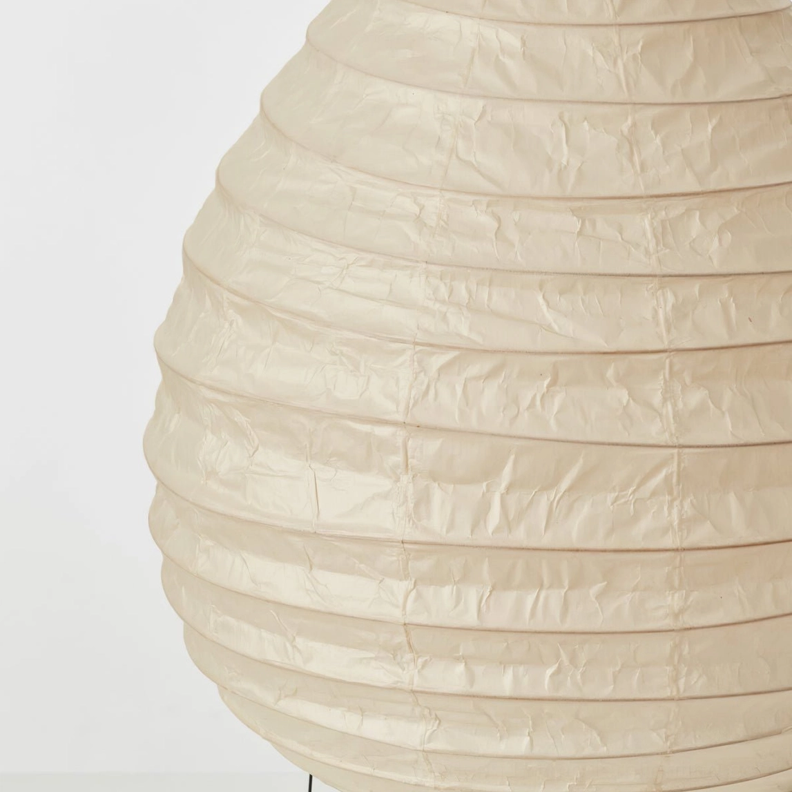 Close-up detail of handcrafted washi paper shade texture showing folded layers and weave pattern