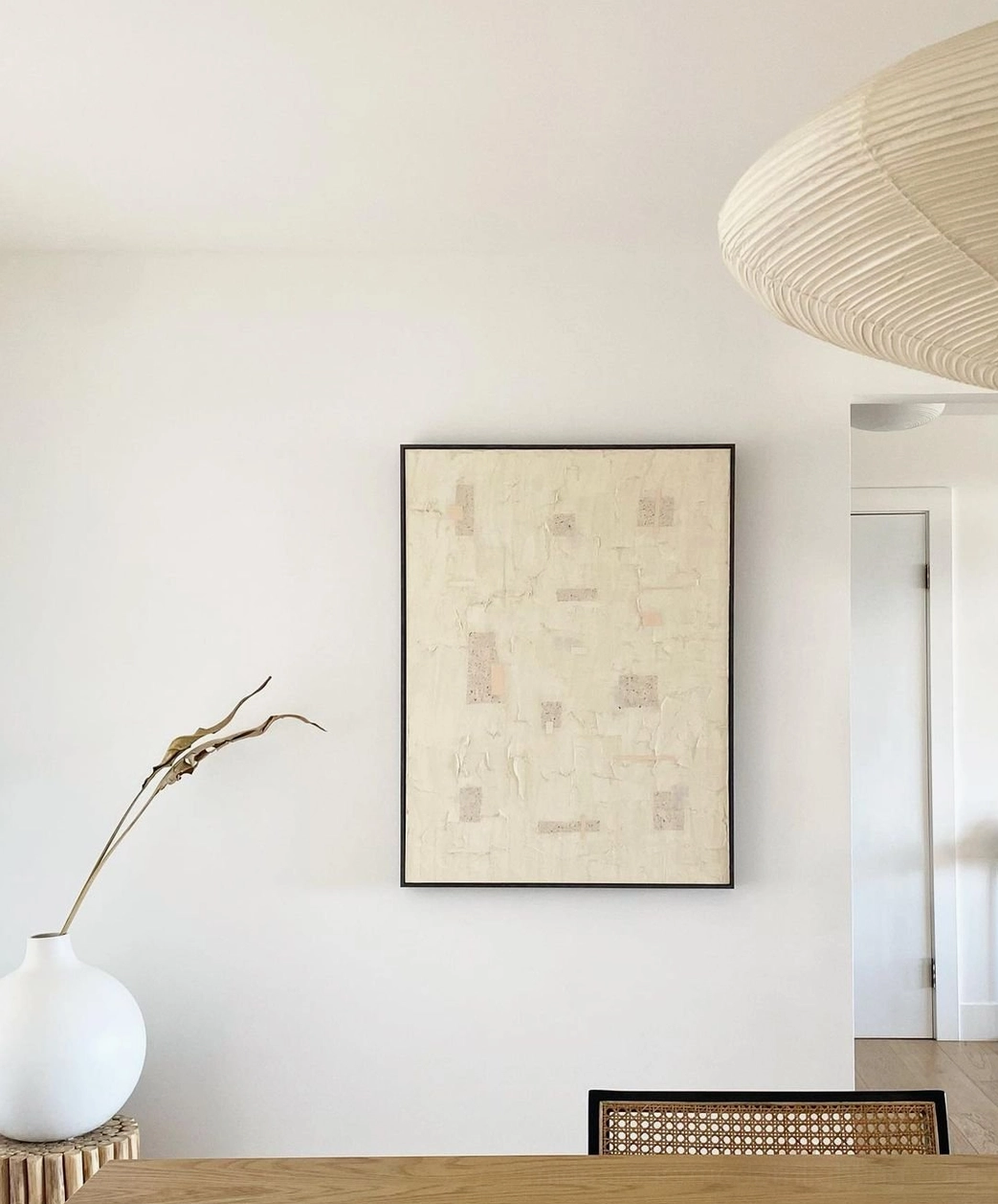 Cluster of multiple washi pendants suspended at varying heights creating dynamic lighting composition