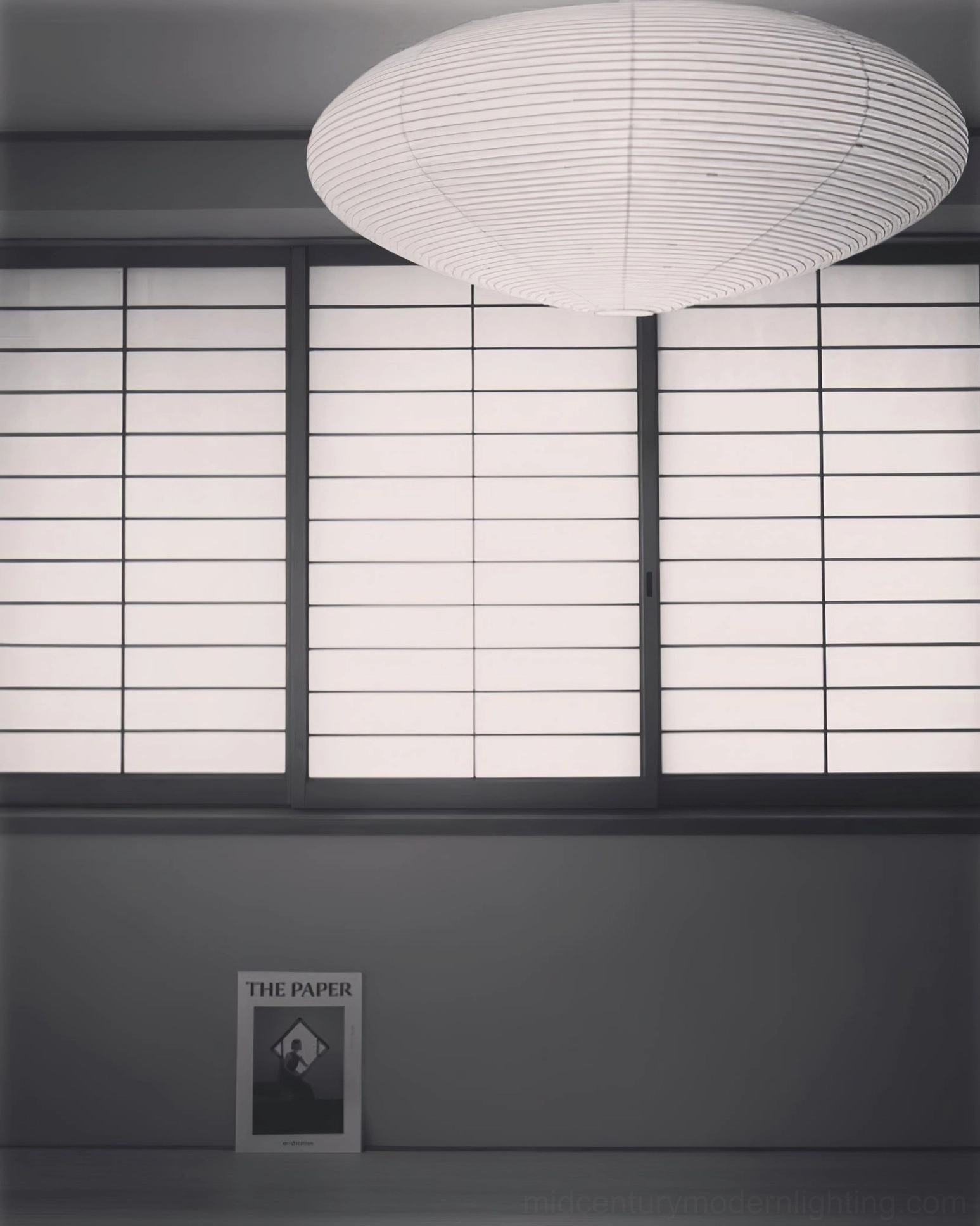 Angled view of washi paper pendant showing three-dimensional drum form and fabric drape