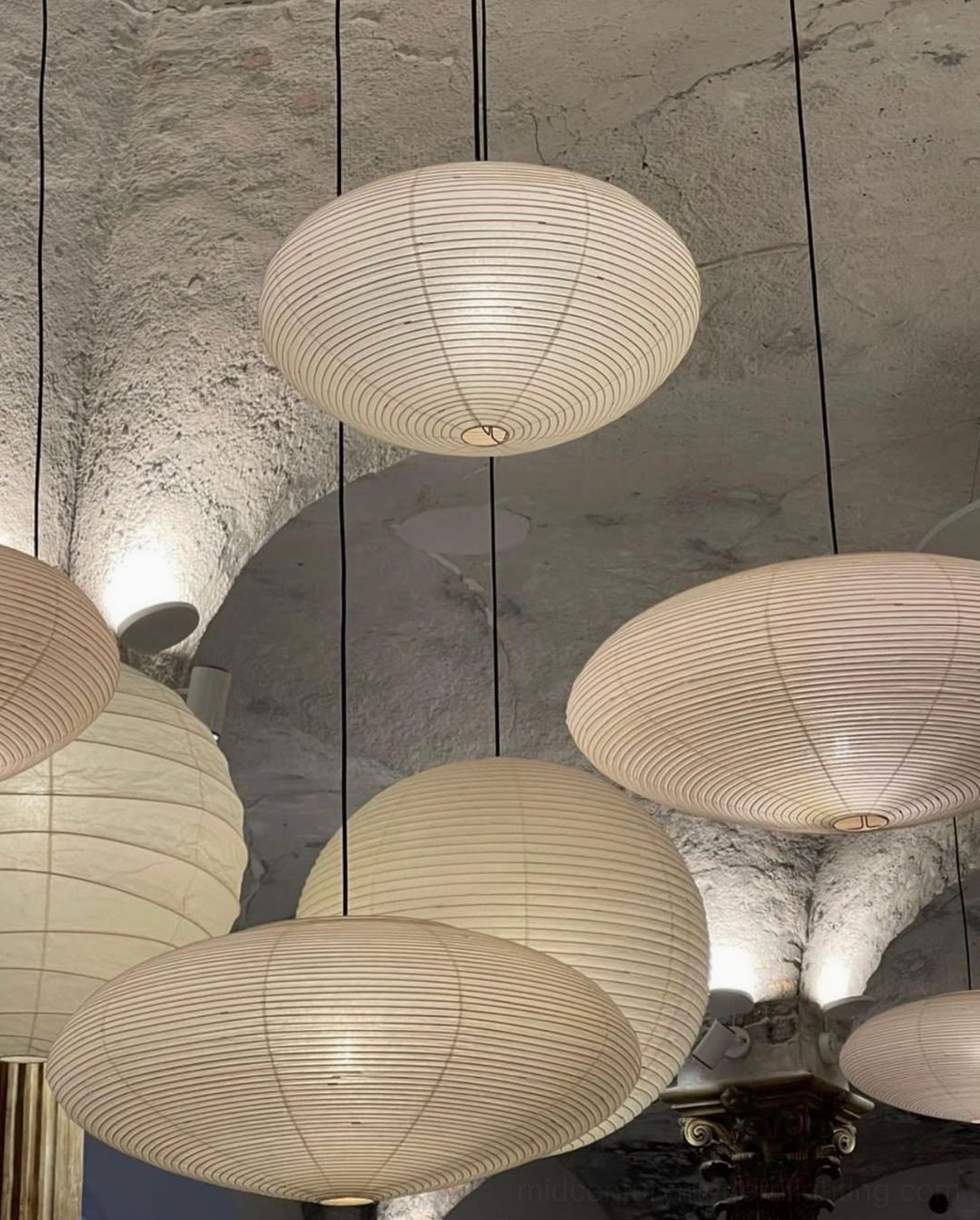 Washi paper pendant light in gallery-style commercial space with high ceilings and minimalist walls