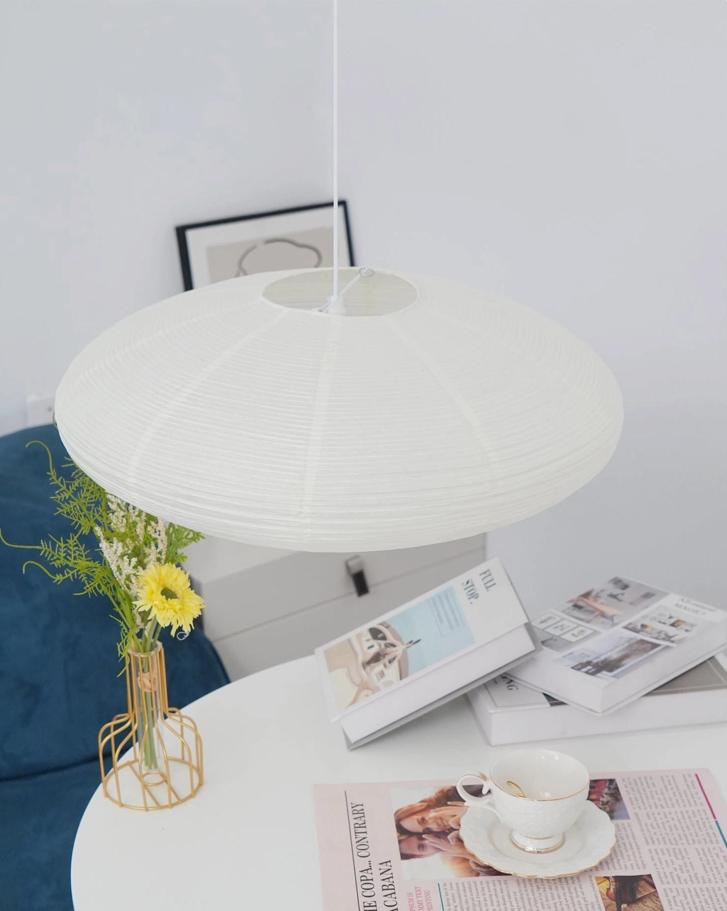 Washi paper pendant light installation detail showing ceiling mounting hardware and cord attachment