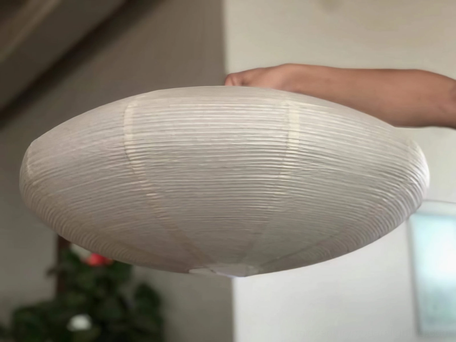 Warm-white LED bulb glowing inside washi paper shade showing recommended color temperature