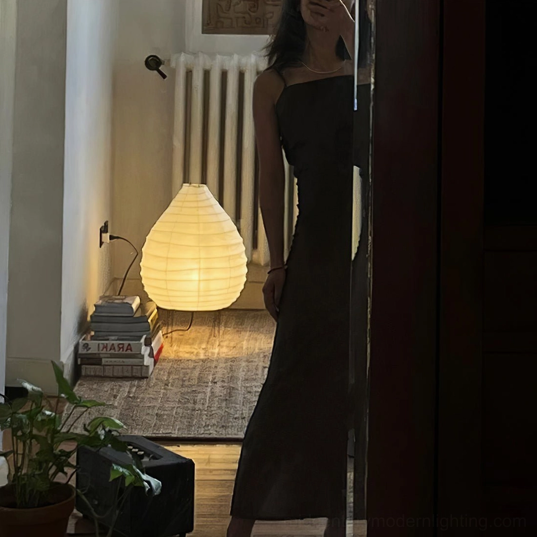 Mulberry paper table lamp in hallway with figure, warm minimalist home decor setting