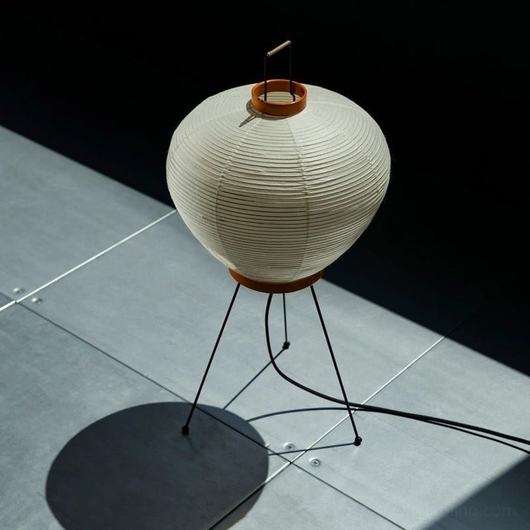 Washi mulberry paper table lamp dramatic studio product photography with grey tile and directional lighting