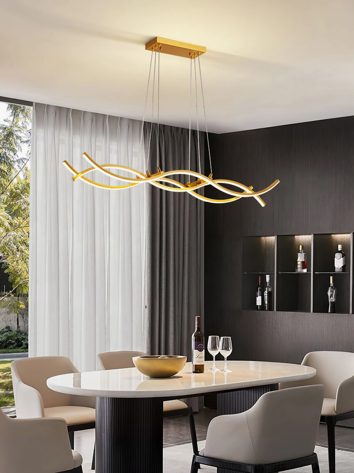 Brushed gold wave pendant chandelier above round dining table with wine service and window view