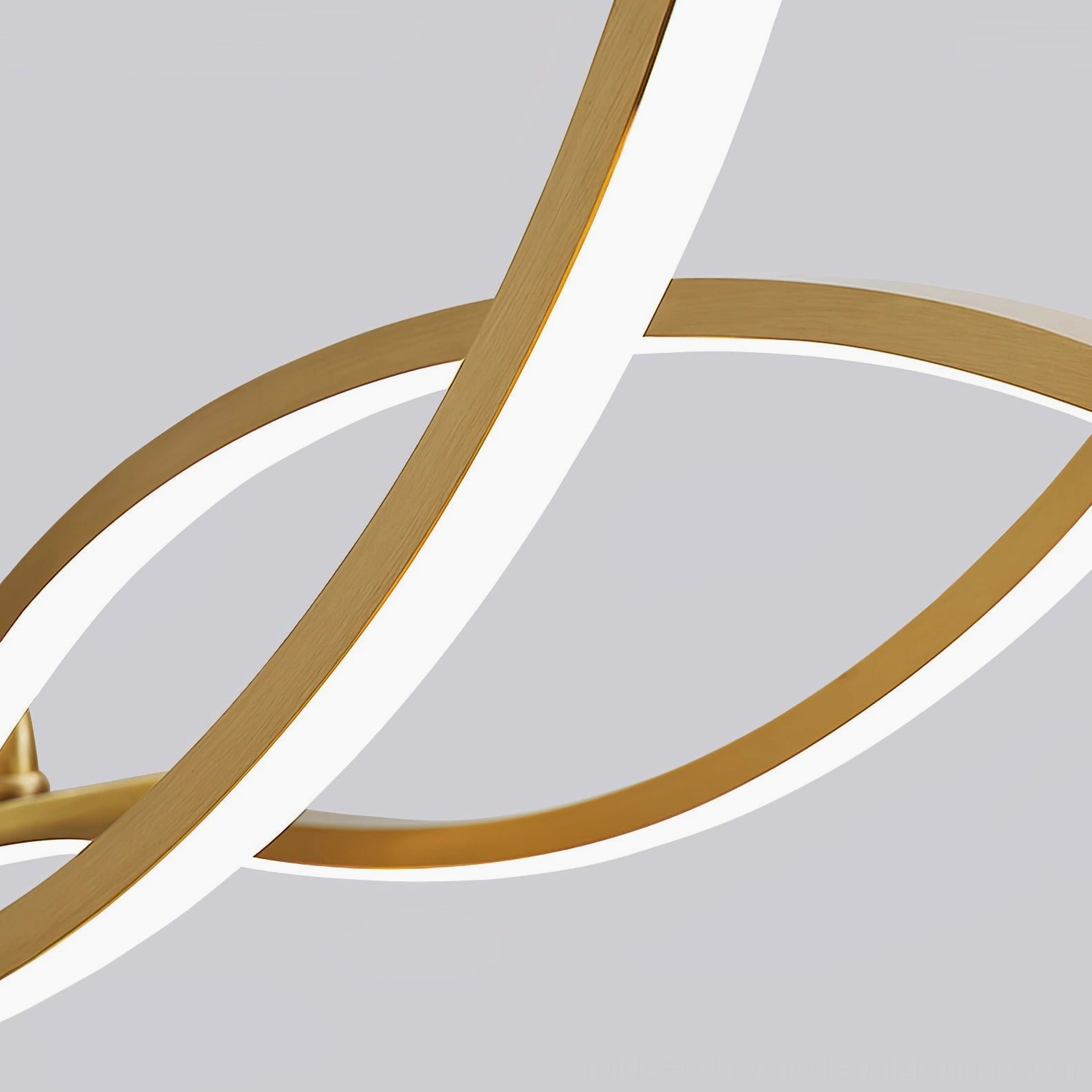 Close-up detail of wave chandelier showing brushed brass frame and integrated warm LED light strip