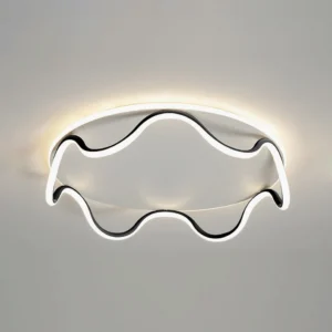 Low-angle view of contemporary wavy LED ceiling light with warm backlight and black metal trim installed on white ceiling
