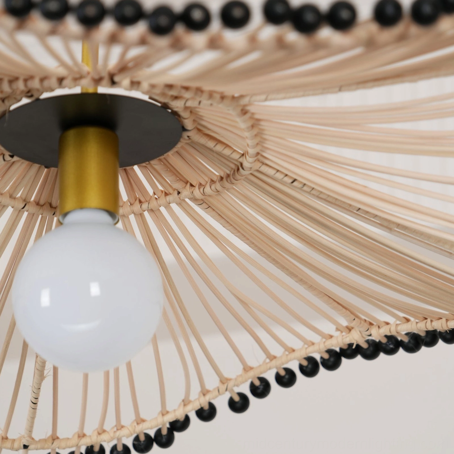 Side profile close-up of rattan pendant showing detailed rattan strand construction and craftsmanship