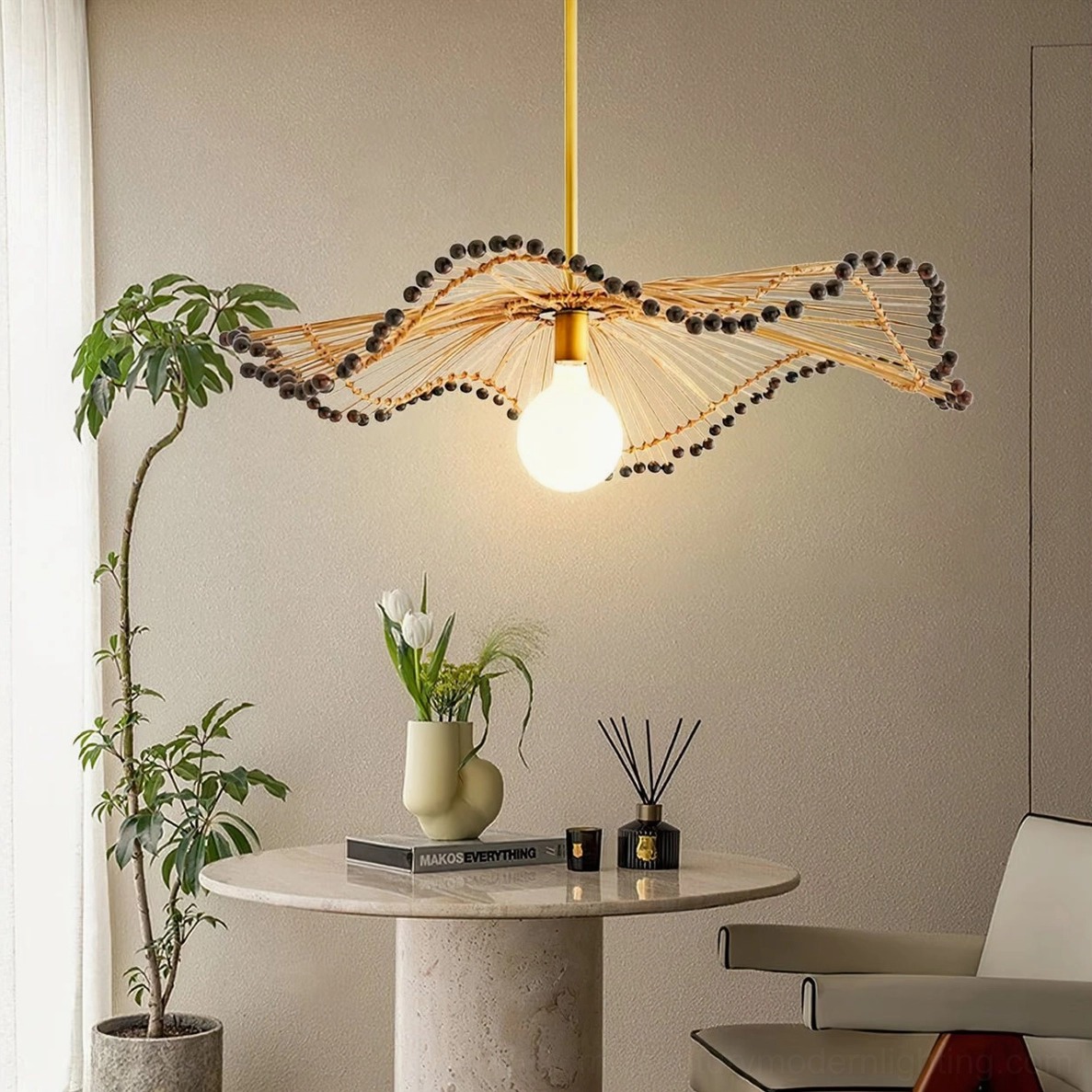 Handwoven rattan pendant light in minimalist dining lounge with green plants and neutral aesthetic