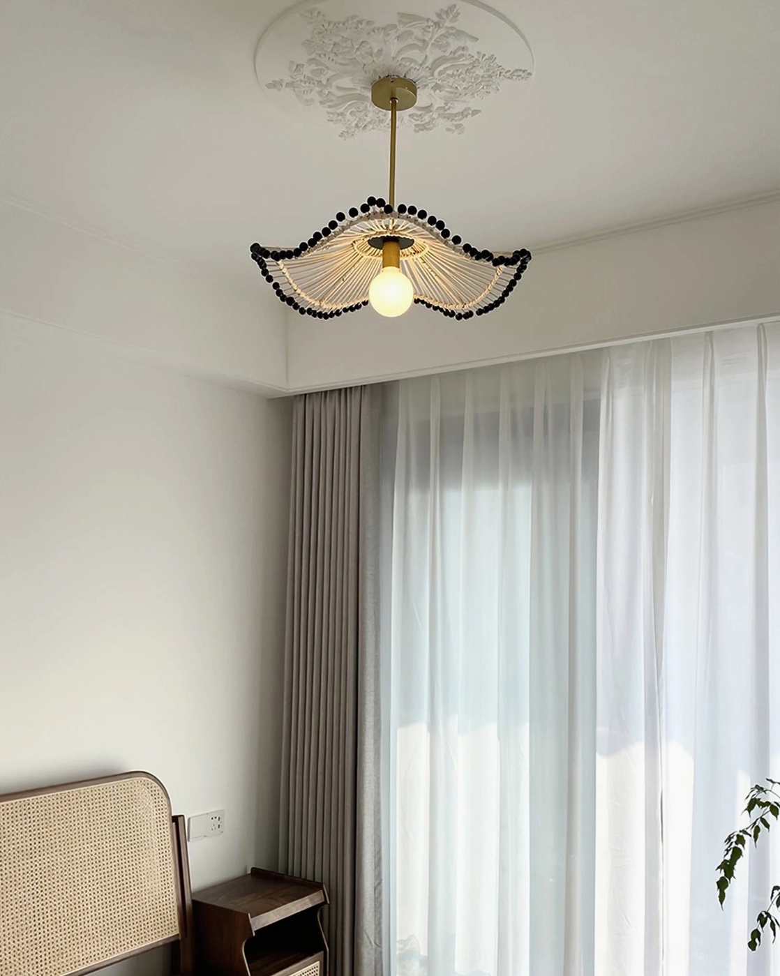 Wide-angle view of Waverly rattan pendant chandelier in spacious bohemian dining environment
