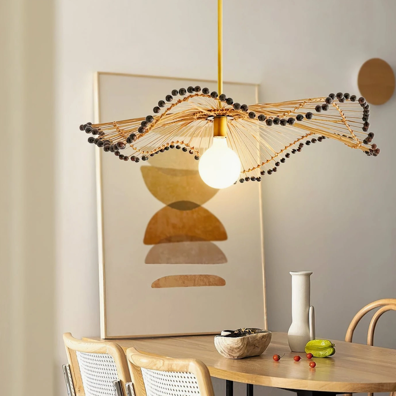 Waverly wavy rattan chandelier in dining room with wooden furniture creating warm bohemian atmosphere