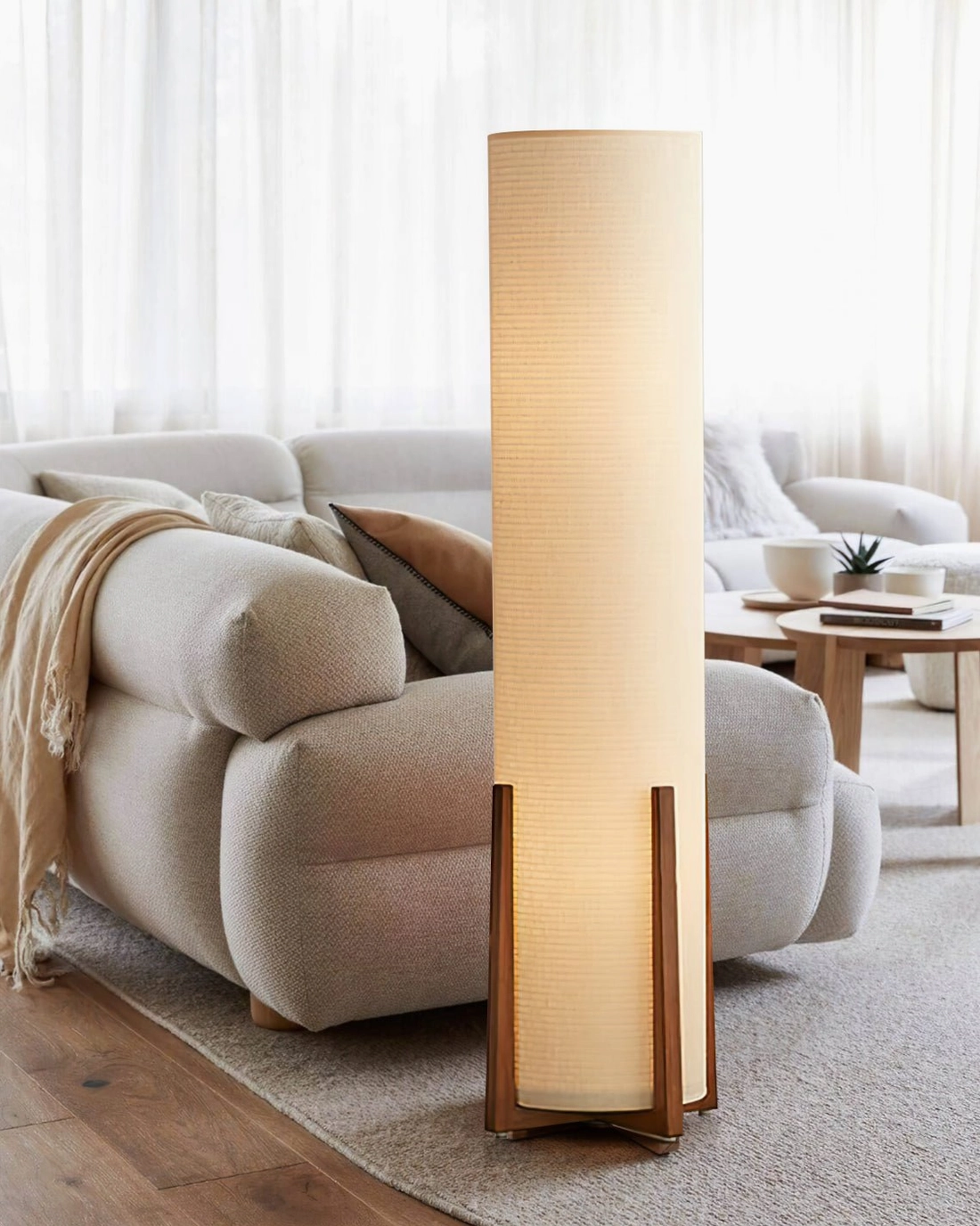 Weave Natural floor lamp with warm glow in cozy fabric sofa living room with sheer window curtains and warm atmosphere