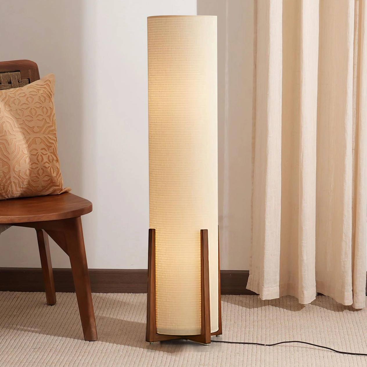 Weave Natural floor lamp with walnut wooden frame and black power cord in warm home setting with wooden chair