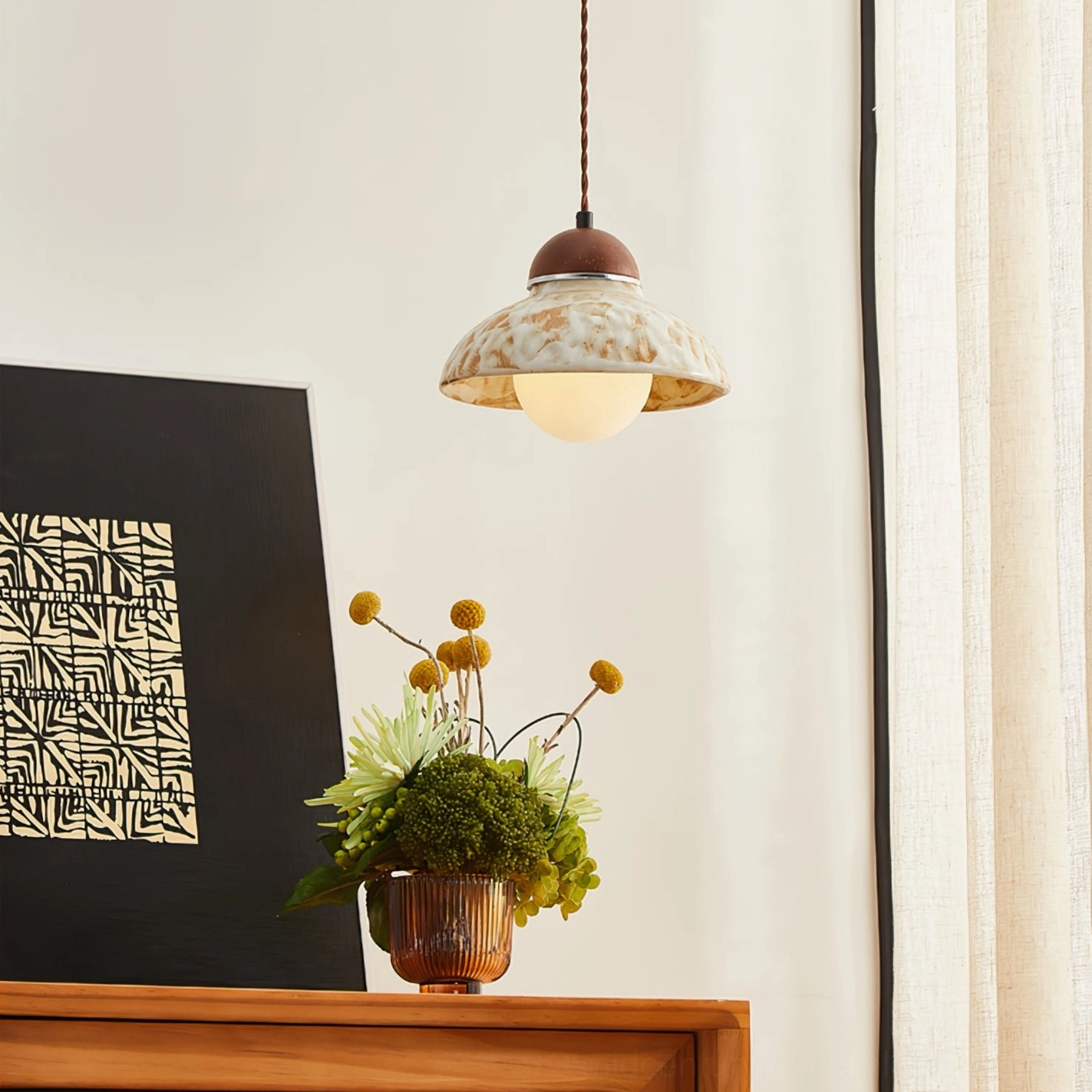 Wella pendant lamp installed in Japanese-inspired home interior with wooden sideboard and ceramic accent pieces