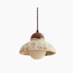 Wella ceramic pendant light with beige marbled glaze and walnut wood canopy against white background, showcasing dome design