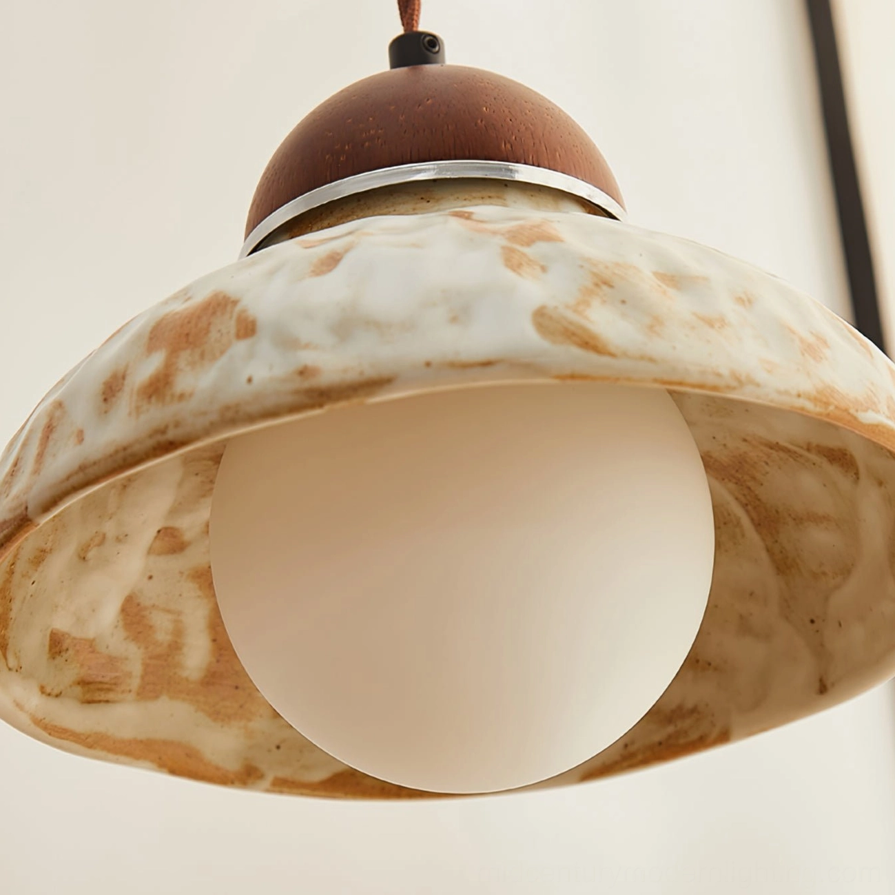 Close-up detail of Wella pendant showing milky frosted glass bulb and silver metal trim with ceramic dome