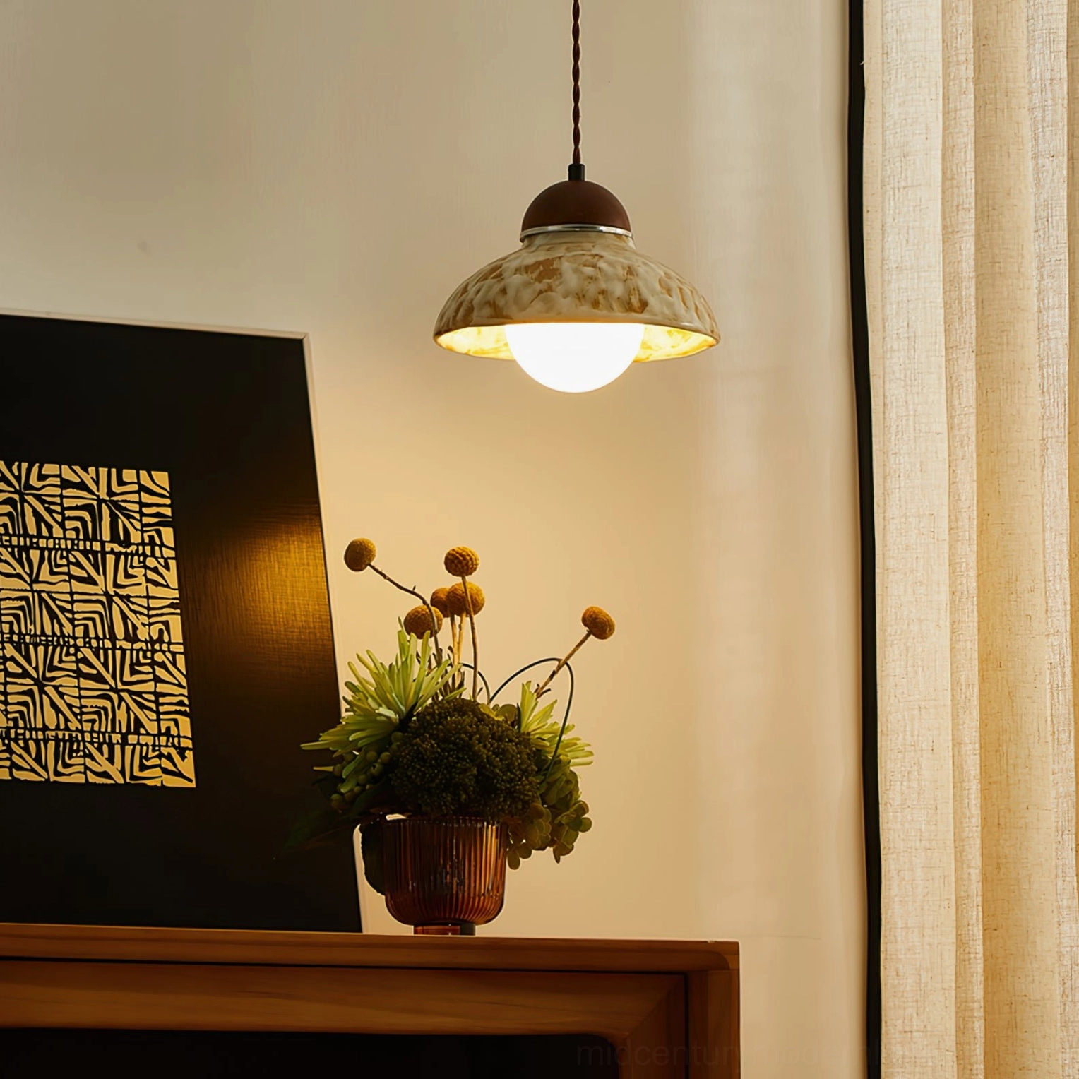 Illuminated Wella ceramic pendant creating warm glow in styled home corner with floral decorative elements